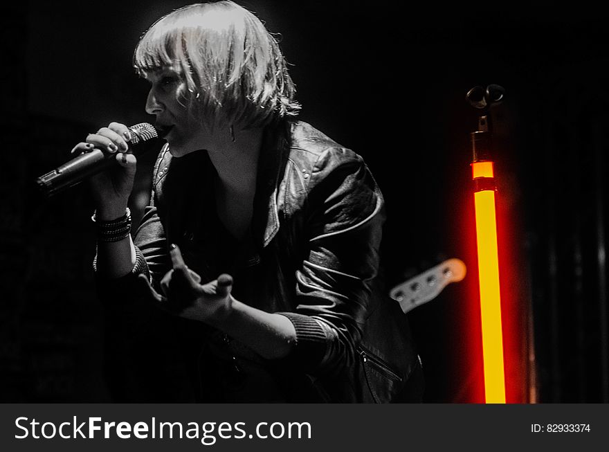 Rock Band Lead Singer Wearing Black Jacket and Wireless Microphone