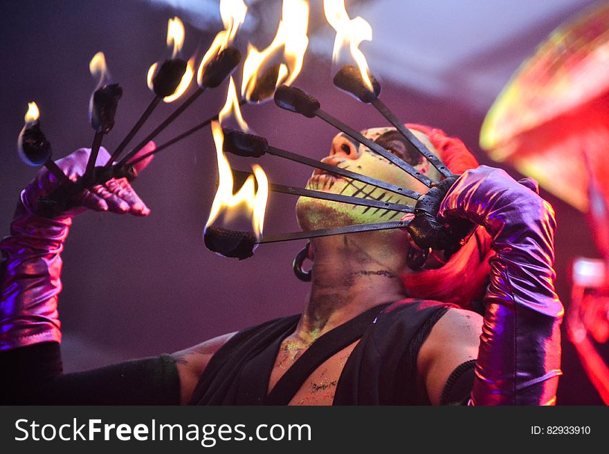 Red Haired Fire Dancer Blowing Rod With Flames