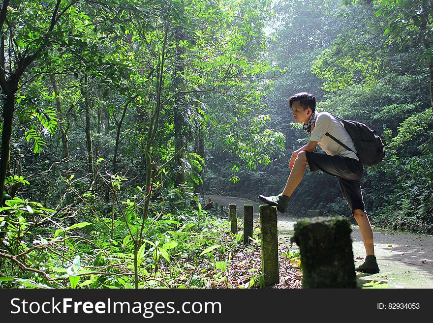 Boy Standing In Black Backpack Standing Near The Fence