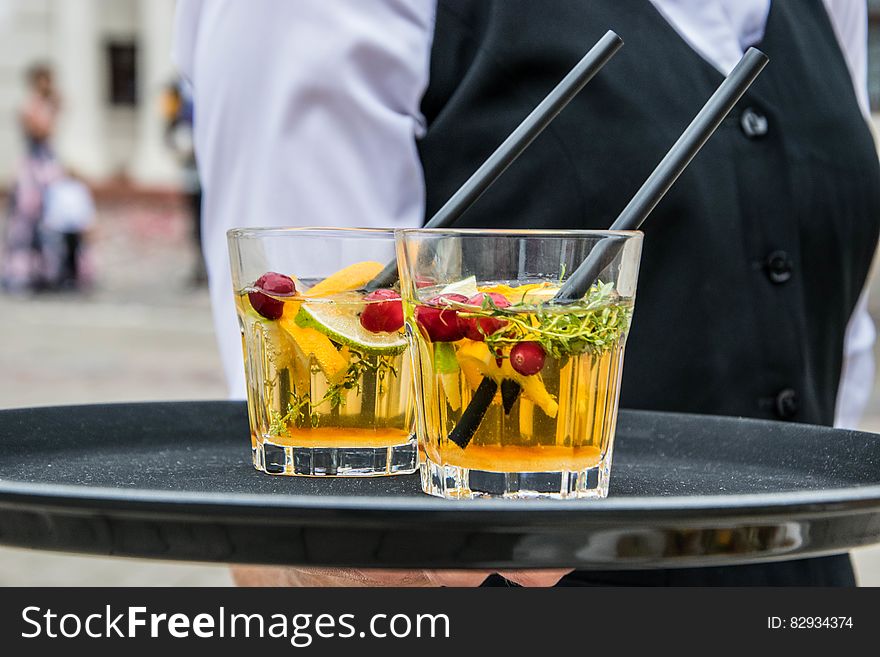 2 Whisky Glasses Filled With Beverage On Black Tray