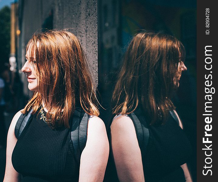 Woman in Black Sleeveless Top Wearing Black Backpack