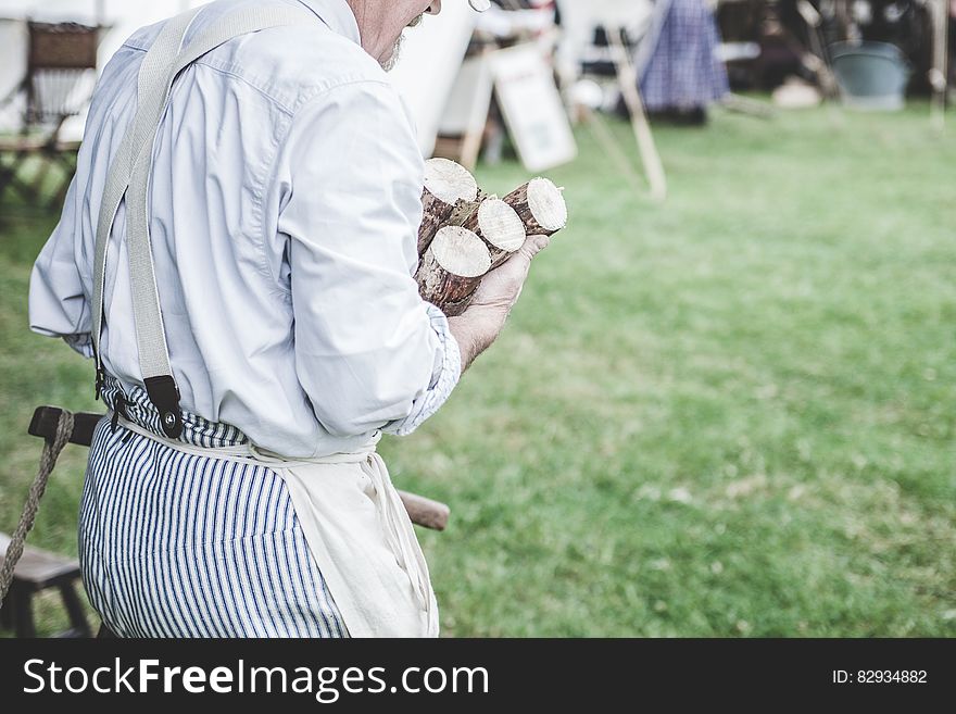 Man In White Dress Shirt Carrying Brown Wood Logs