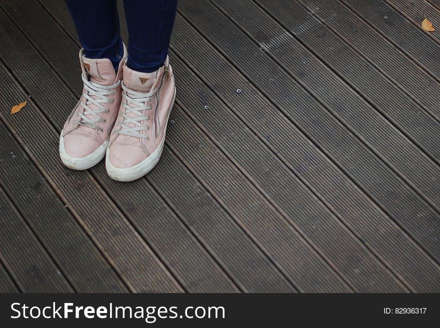 Person Wearing Pink and White High Top Sneakers