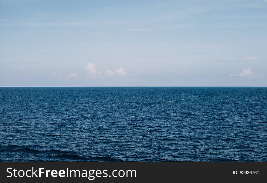 Water horizon against blue skies on sunny day. Water horizon against blue skies on sunny day.