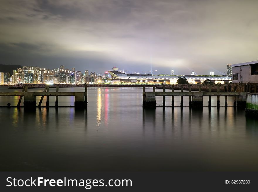 Cityscape View over Sea With Lights Turned on during Night