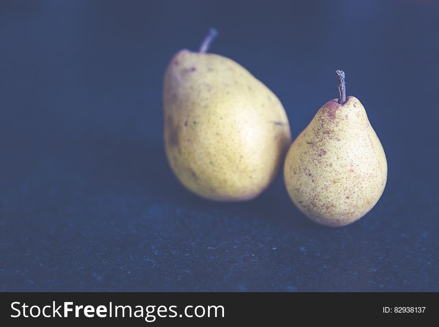 Tilt Shift Photo of Two Pears