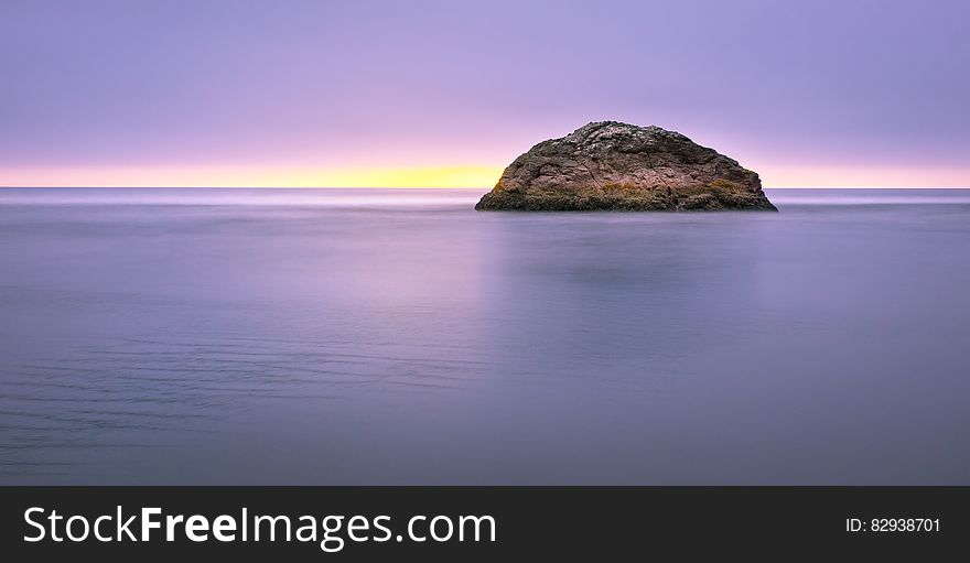 Photo of Island on Sea during Sunset