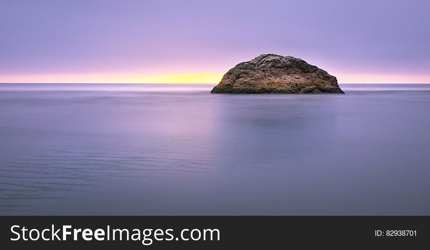 Photo Of Island On Sea During Sunset