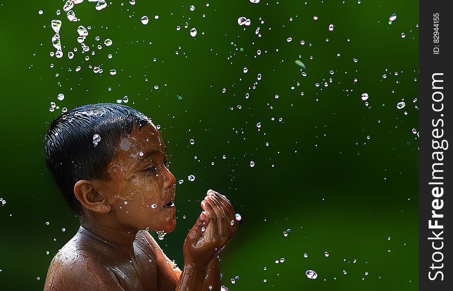 Wet Boy With Water Droplets in Slow Motion Photography