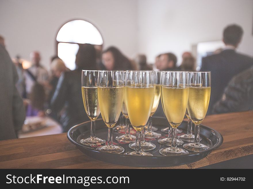 Glasses of champagne or sparkling wine on a serving tray at the bar. Glasses of champagne or sparkling wine on a serving tray at the bar.