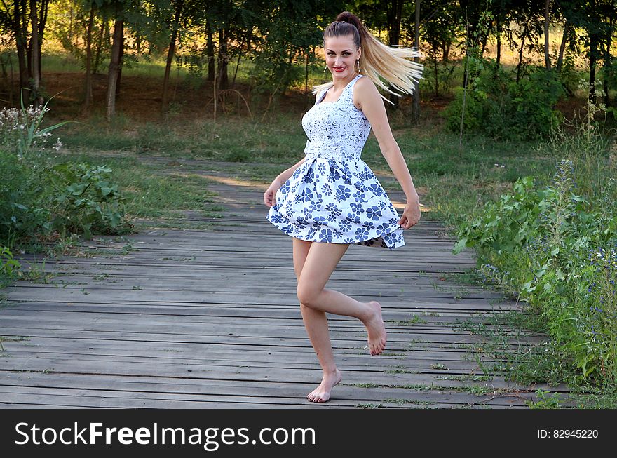 Woman in Blue and White Skated Dress