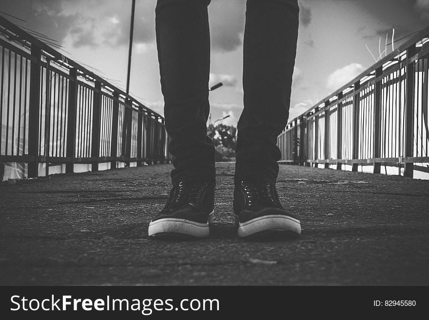 Person in Black Skinny Jeans Standing at the Center of Road