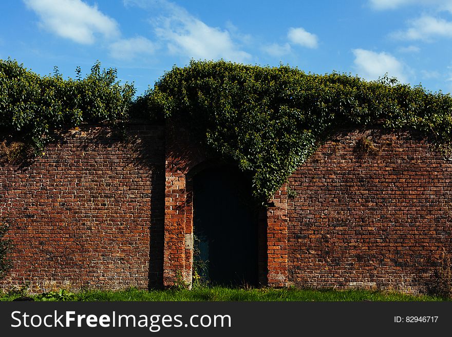 Tall Brick Wall With Closed Garden Gate