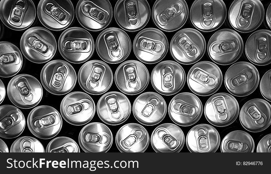 Tops of aluminum cans in black and white.