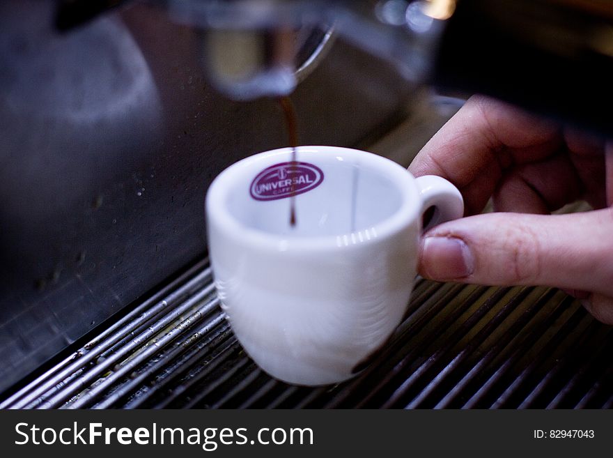 Person Holding White Ceramic Teacup