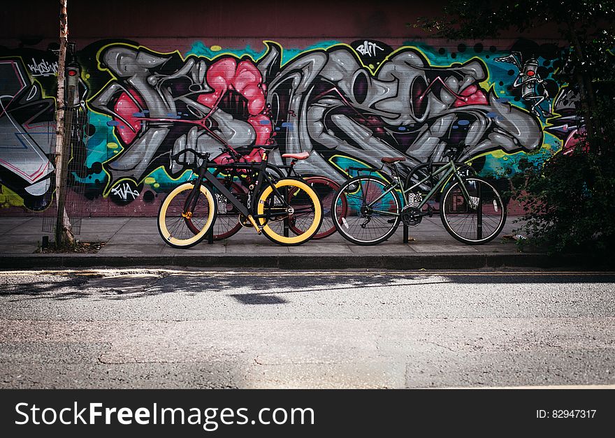 Black and Yellow Fatbike Beside Mountain Bikes