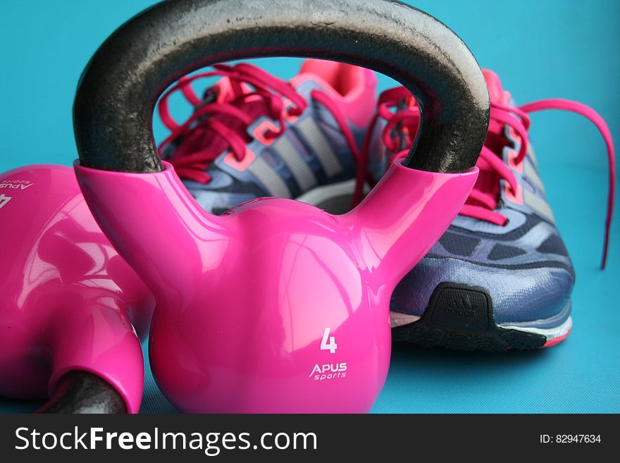 Kettle Bell Beside Adidas Pair of Shoes