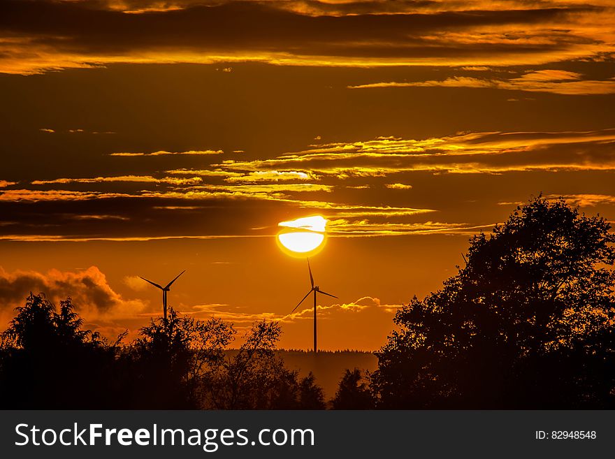 Wind turbines in country field at sunset. Wind turbines in country field at sunset.