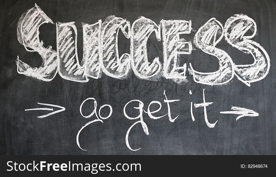 Success, go get it, in white chalk on blackboard. Success, go get it, in white chalk on blackboard.