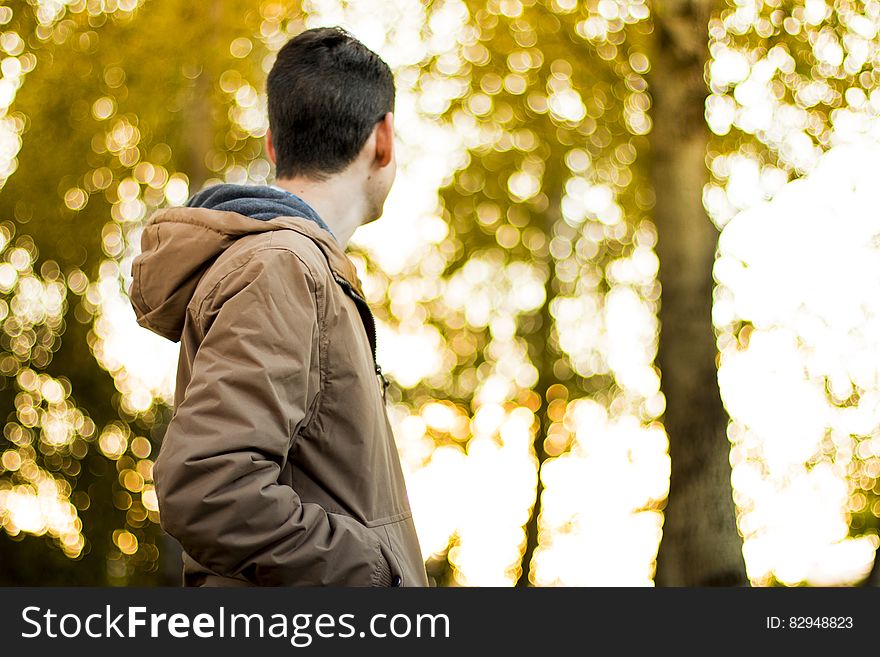 Man standing outdoors in autumn foliage on sunny day. Man standing outdoors in autumn foliage on sunny day.