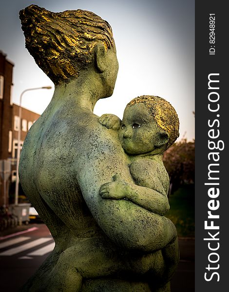 Statue of a mother holding her child. Statue of a mother holding her child.