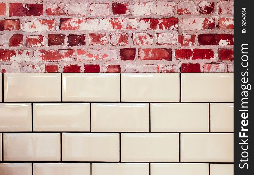 White Ceramic Wall Tile Beside Red Concrete Bricks