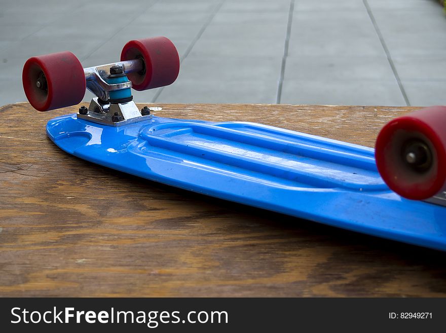 Blue Penny Board on Wooden Table