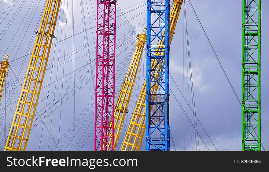 Blue Yellow Red And Green Metal Bar With Metal Sprint In Low Angle Photography