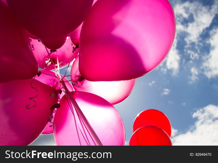 Pink and Red Balloons during Daytime