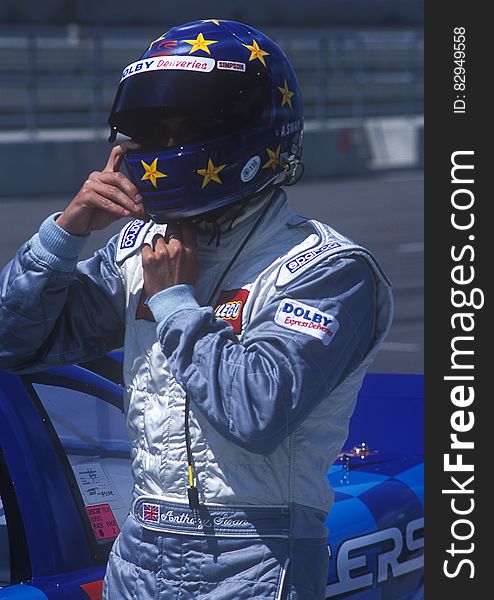 Man In Blue And And White Racer Suit Wearing His Blue And Yellow Star Full Face Helmet