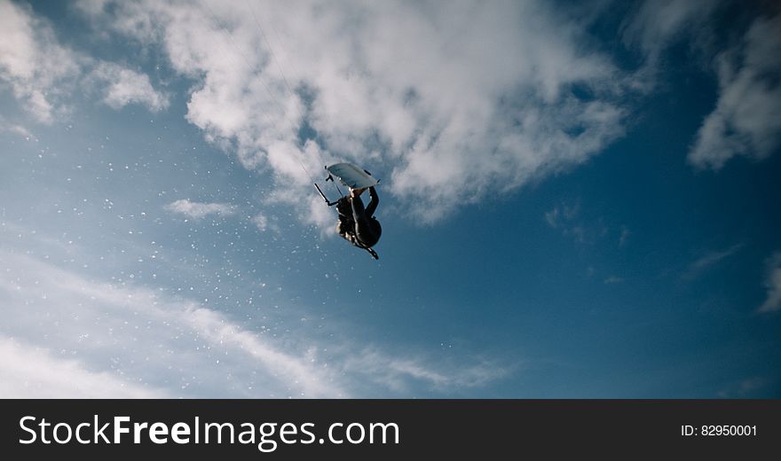 Low Angle Photo of Wakeboarder in the Sky