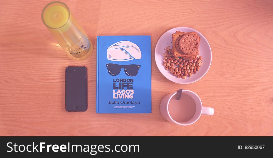 Peanuts and Biscuits in White Ceramic Plate Beside White Ceramic Mug Near Lagos Living Book