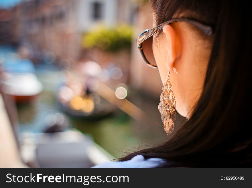 Woman Wearing Pendant Earrings And Sunglasses