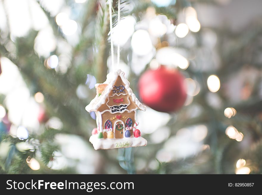 Gingerbread house ornament on Christmas tree.