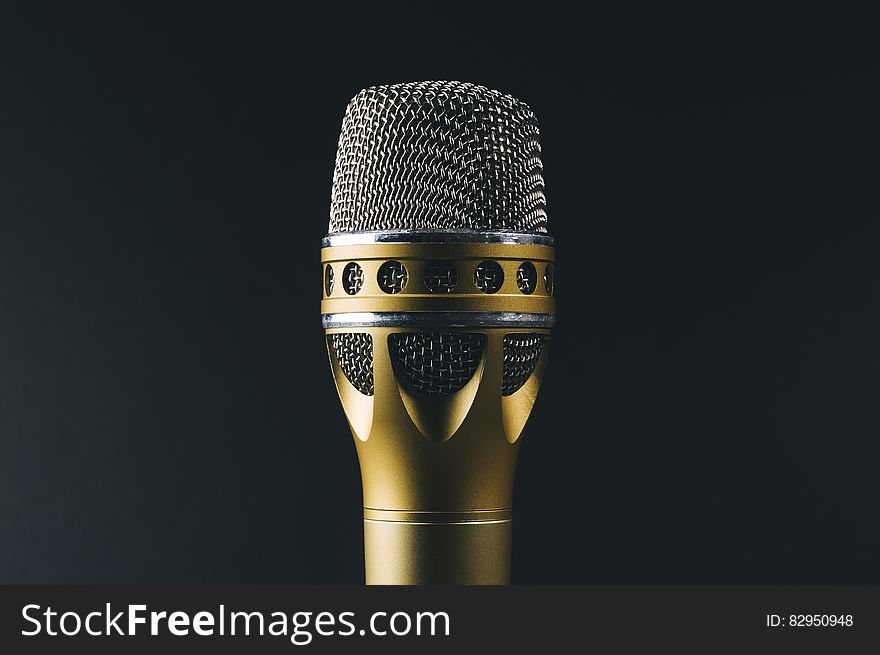 Vintage chrome and gold microphone on black. Vintage chrome and gold microphone on black.