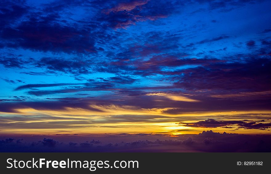 Blue and gold skies on horizon at sunset. Blue and gold skies on horizon at sunset.