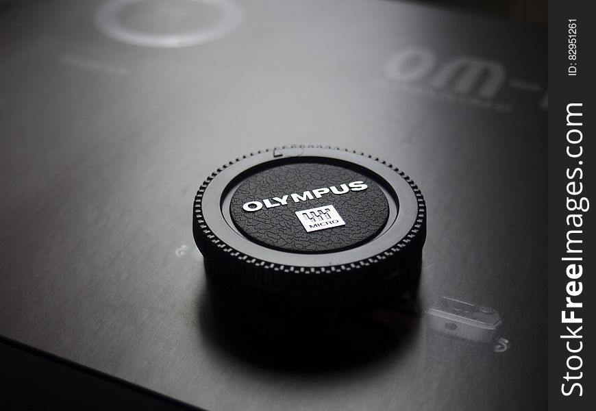 Olympus Camera Lens Cap Placed On Box