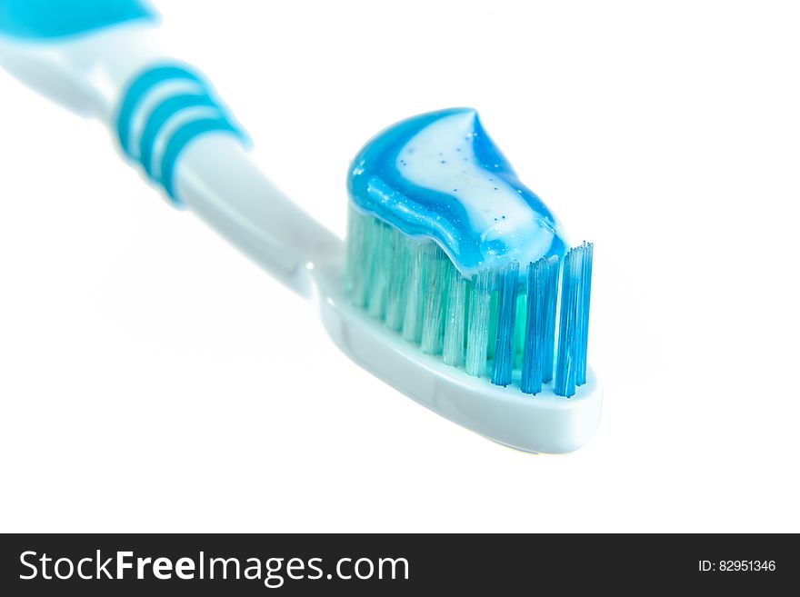 Blue and White Toothpaste on Toothbrush