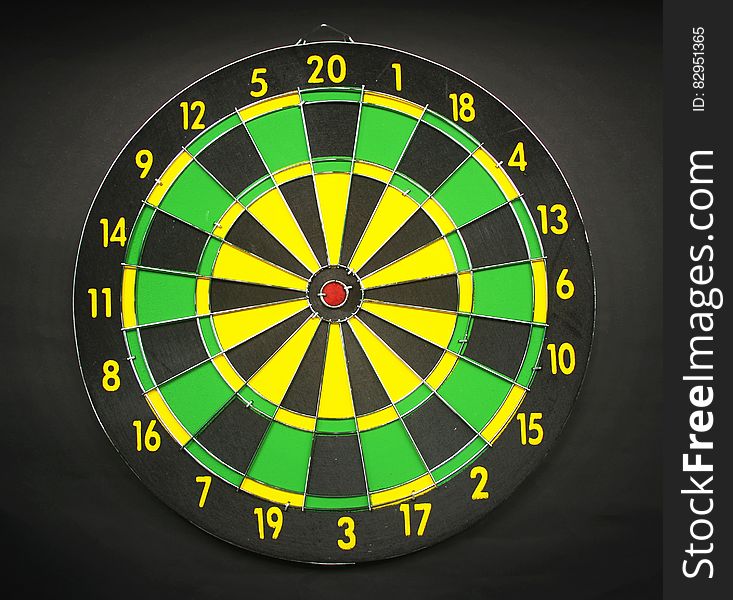 Green Yellow and Black Round Dart Board With Black Background