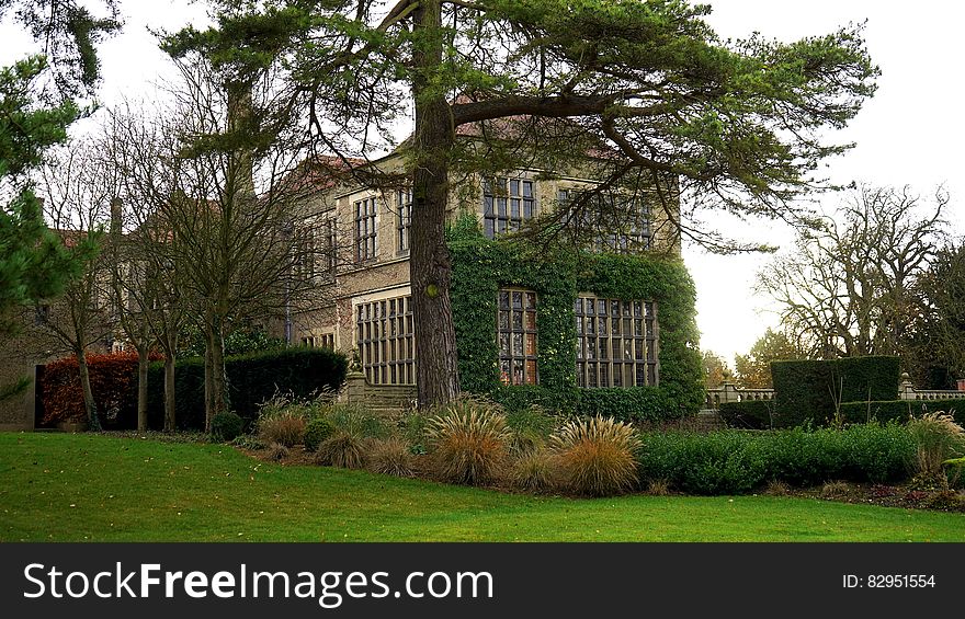 Exterior of stately home and ground on sunny day. Exterior of stately home and ground on sunny day.