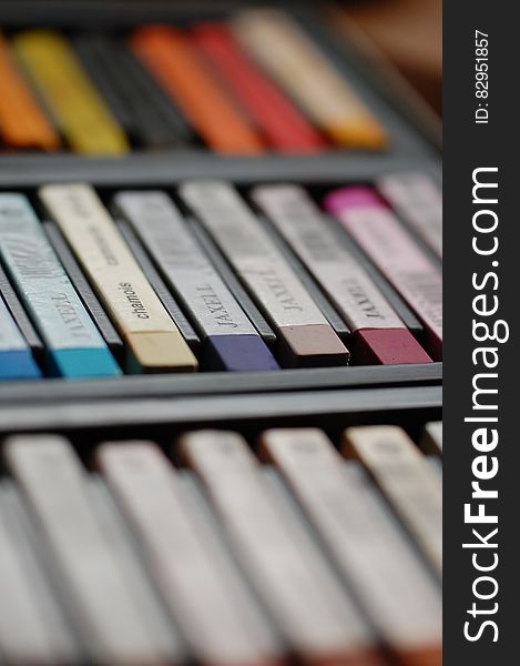 A close up of a palette of different crayon colors.