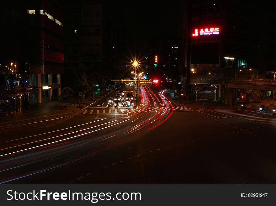 Streaks of headlights and taillights on city streets at night.