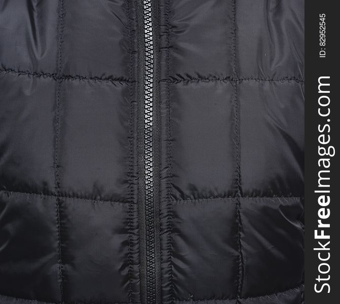 Close Up Shot of Black Zip Up Quilted Textile