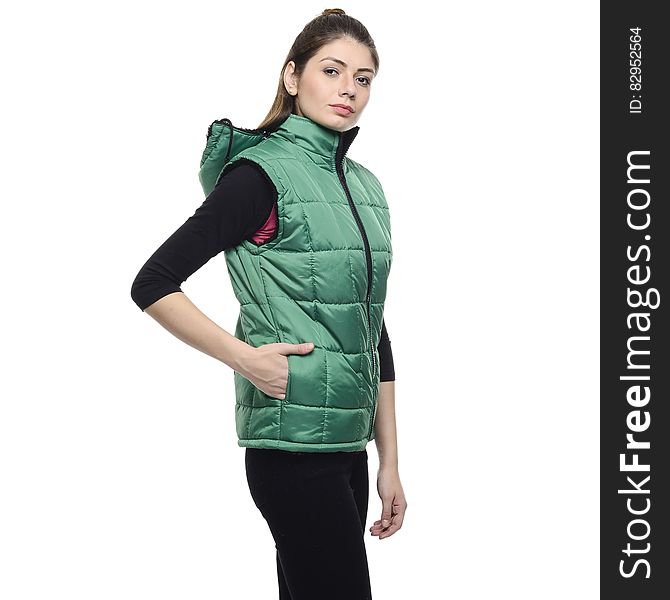 Woman Wearing a Green Puffer Vest and a Black Pants