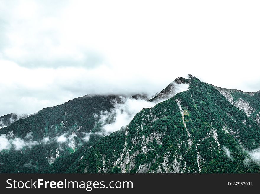 Fog Over Snowy Mountain Peaks