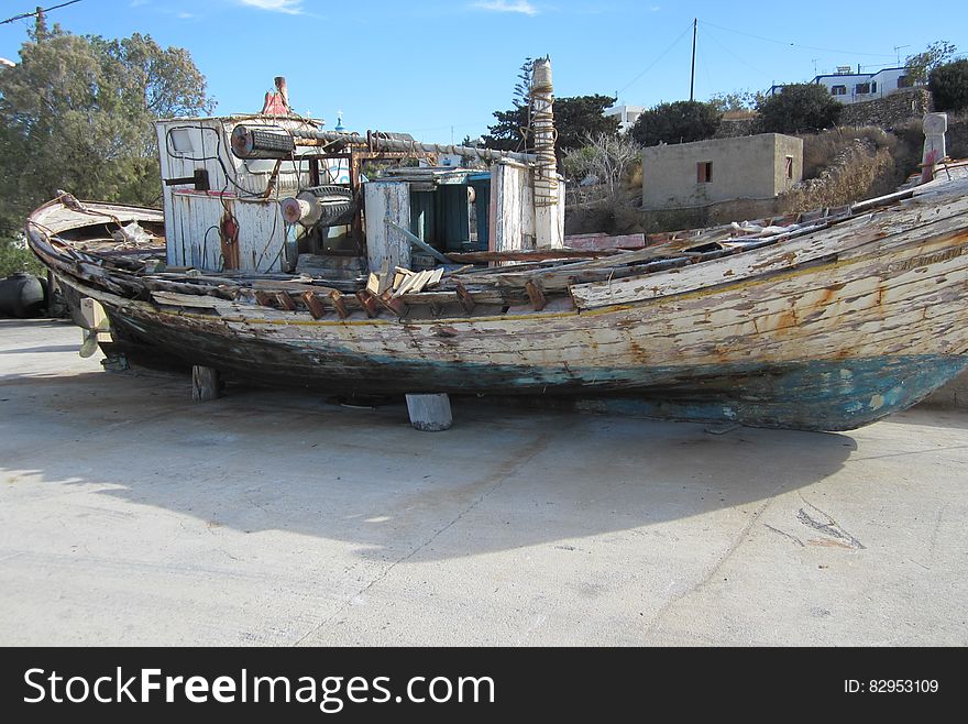 Wreck of wooden boat in dry dock.