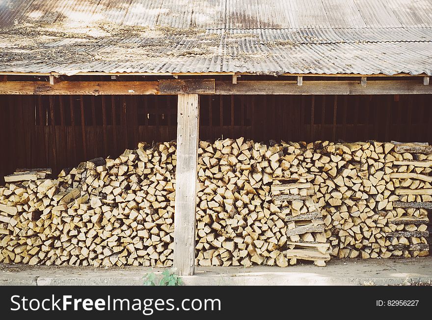 A huge stack of firewood in a stock. A huge stack of firewood in a stock.