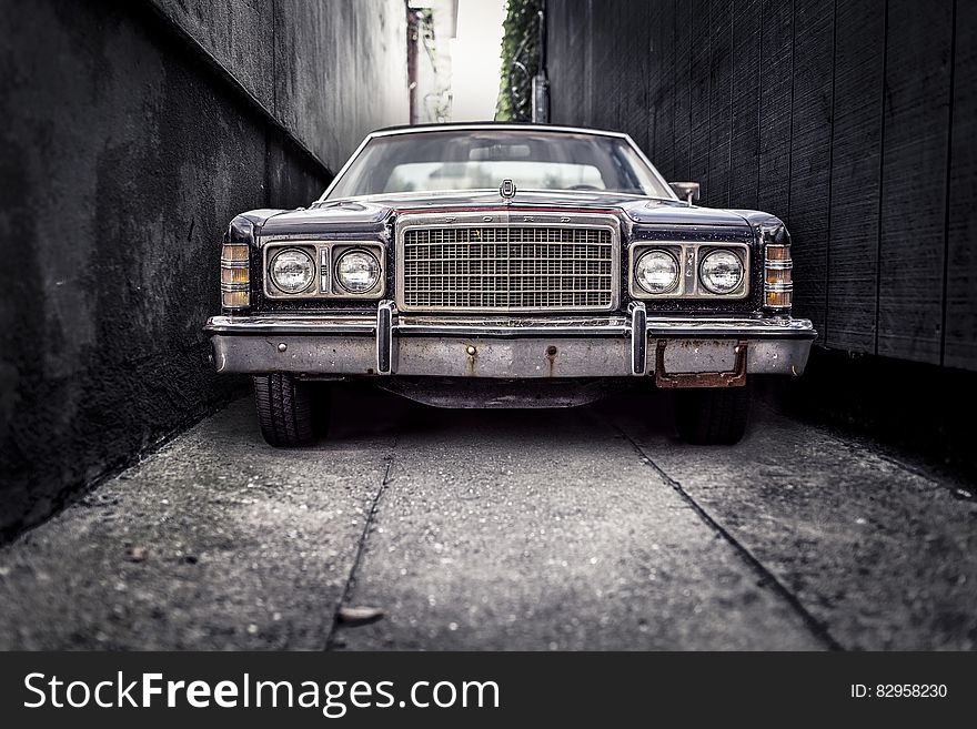 Front of vintage car in narrow alleyway. Front of vintage car in narrow alleyway.