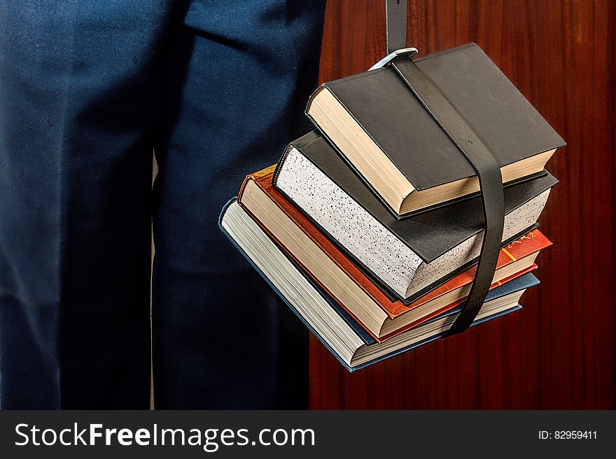 Black Leather Book Strapped Around Four Books