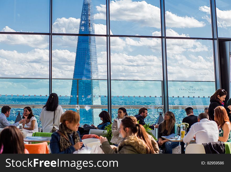 Diners seated at tables inside modern restaurant in downtown London, England. Diners seated at tables inside modern restaurant in downtown London, England.